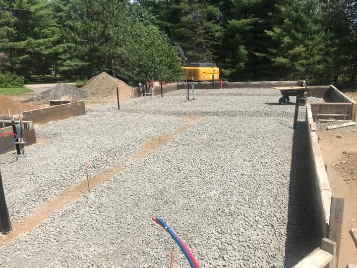 Gravel sub-base laid for a new home foundation before a radon-resistant system install in Urbandale, IA